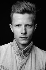 Punk rocker man against black background in black and white