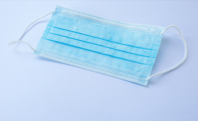 close-up of one blue  facemask on white background