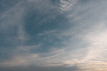 Sunset cloudy blue sky with the orange sun