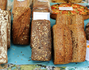 Whole grain rye bread with seeds for slices cooked in a wood oven, organic food market