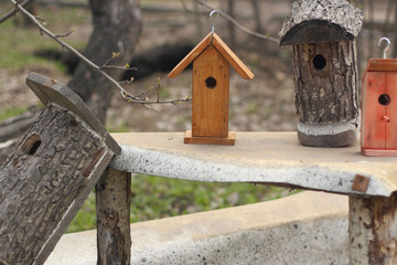 Homemade wooden  birdhouses in the park. Handmade craft for birds. 