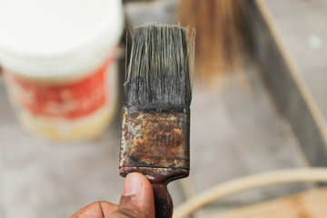 a paint brush held in hand
