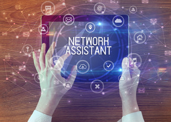 Close-up of a tablet with NETWORK ASSISTANT inscription, innovative technology concept