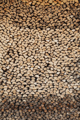 Precisely layered pile of wood from different cut firewood, heating material, sustainable reforestation