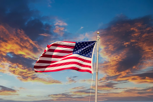 American flag waving in the wind on a Sunset sky