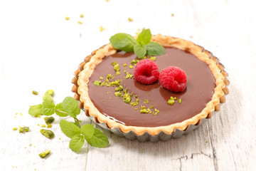 chocolate tartlet with berry fruit and pistachio