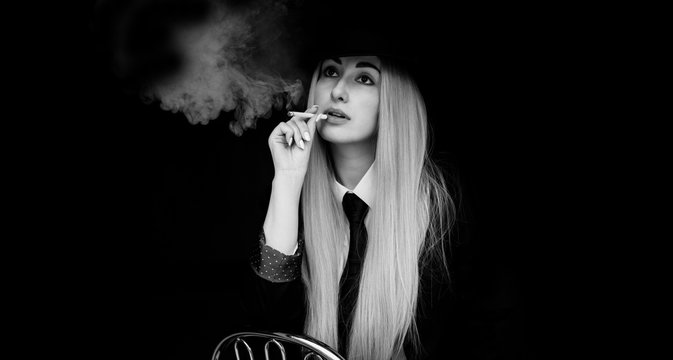 Elegant woman smoking, cinema style, artistic commercial photo for some campaign