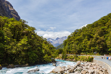 Landscape with road, river and snow-capped mountains. Fiordland, New Zealand