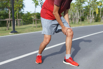 Sport man suffering with pain on sports running knee injury after running.Injury from workout concept