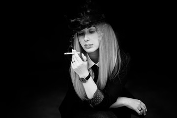 Obraz premium Elegant woman smoking, cinema style, artistic commercial photo for some campaign
