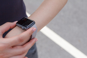 Close up woman looking at heart rate on the smart watch.