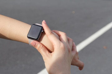 Close up woman looking at heart rate on the smart watch.