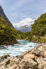 Landscape with a fast river against the background of mountains. South Island, New Zealand