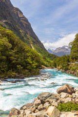 Landscape with a fast river against the background of mountains. New Zealand