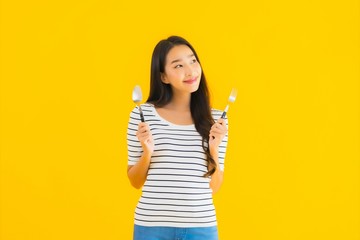 Portrait beautiful young asian woman show spoon and fork ready to eat