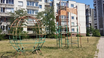 Fototapeta na wymiar Soviet times playground and apartment buildings