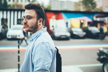 Calm hipster walking in street