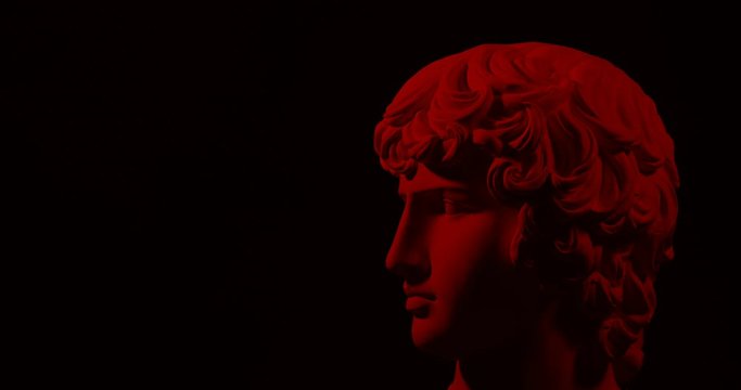 Epic studio shot of rotating gypsum head with dramatic red lighting. With free copy space for inscription or infografics. On black background isolated 4k