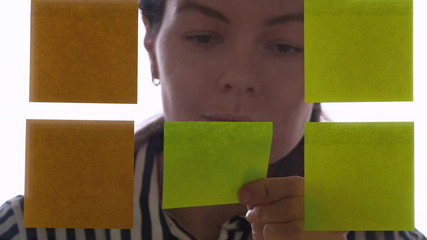 Project management and schedule planning, concept. A young woman takes notes