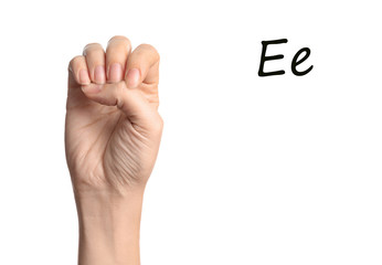 Woman showing letter E on white background, closeup. Sign language