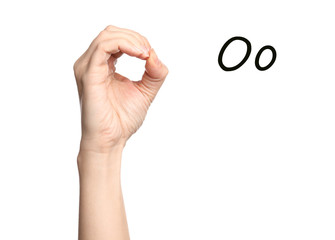 Woman showing letter O on white background, closeup. Sign language