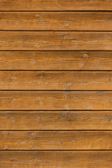 Closeup of texture of weathered varnished wooden wall. Aged wooden plank fence. Copy space