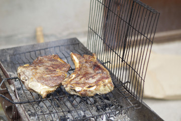 Grilled meat on a barbecue grill.