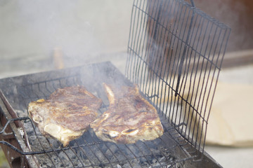 Grilled meat on a barbecue grill.