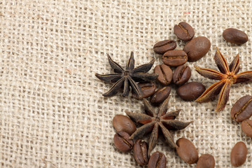Obraz na płótnie Canvas Picture of roasted coffee beans and star anise on rug and wooden table