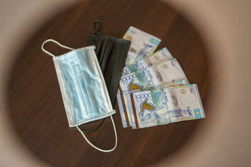 Medical antibacterial masks against coronavirus and money.