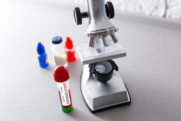 Coronavirus Covid 19 infected blood sample in sample tube in hand of scientist doctor biohazard protection clothing in coronavirus covid 19 research laboratory, Coronavirus Covid-19 vaccine research