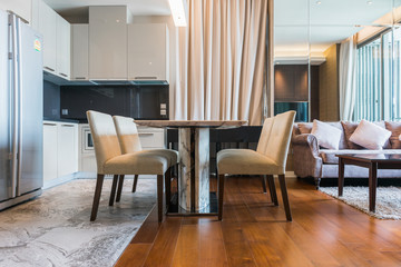 Stylish kitchen interior with dining table and chairs