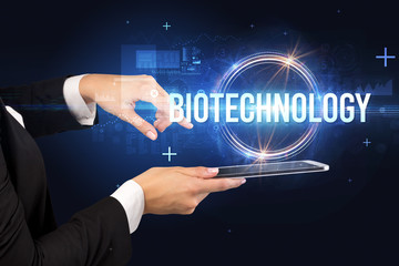 Obraz premium Close-up of a touchscreen with BIOTECHNOLOGY inscription, new technology concept