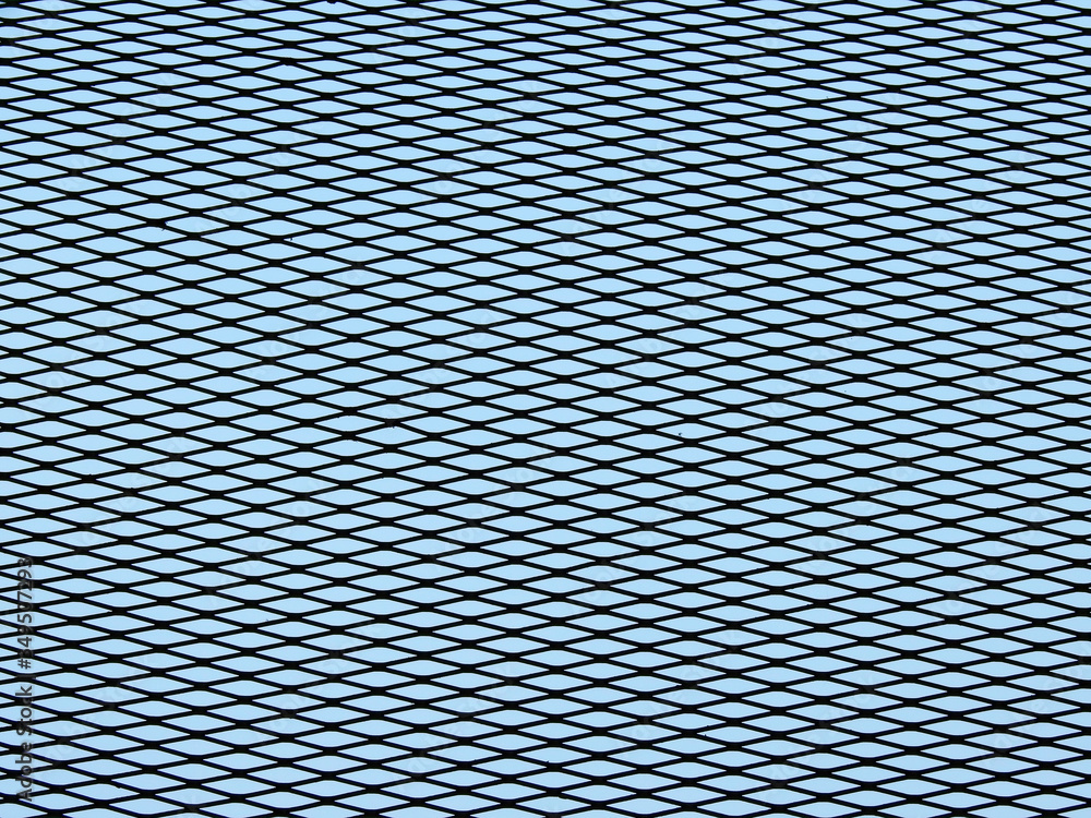 Wall mural wire mesh of fence with blue sky background