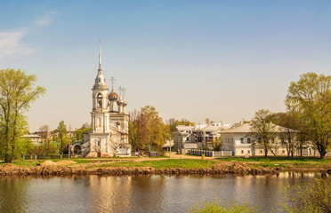 Fototapeta premium Ancient Sretensky temple on river bank in ancient Russian city of Vologda