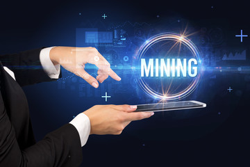 Close-up of a touchscreen with MINING inscription, new technology concept