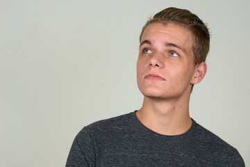 Obraz premium Face of young handsome man with blond hair thinking