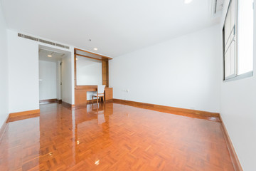 Empty room with big window in loft style. Wooden floor