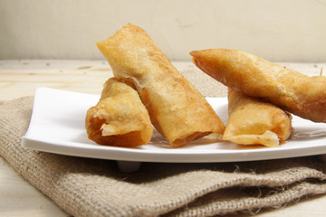 Group of rissoles on a white square plate