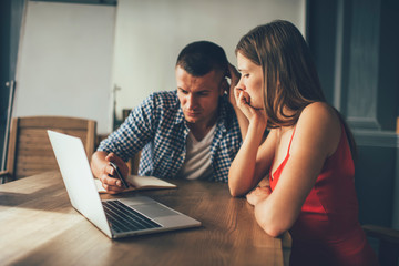 Worried freelancer showing phone to colleague