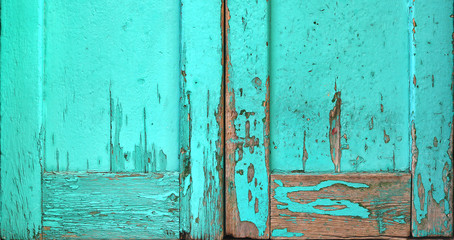 old worn wooden surface painted in turquoise blue with rough texture with scratches - aged door wallpaper background for a blog
