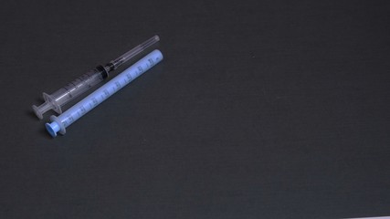 On gray background gloomy syringes. The concept of medicine and drug addiction.