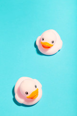 Pink rubber ducks organized on blue background. Vertical foto