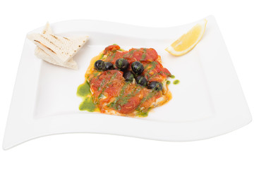 Stewed fish fillet under vegetables with pesto.