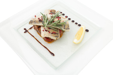 Fried fish fillet on a vegetable bed.