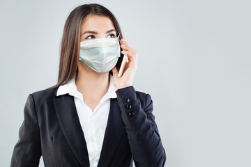 Woman in protective mask using smart phone