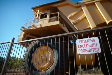 Obraz premium Entering enclosured prohibited sign placing on the face when haul track heavy duty equipment parked 
