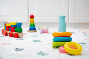 Top view on Colorful Baby Toys on a Carpet Background Toys in the floor with Copy Space for Text