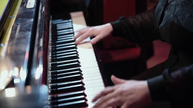 the musician plays the piano and synthesizer close up