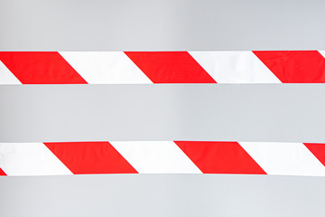 Red white signal striped interdictory tape. Striped line isolated on gray background. Plastic warning tape. 